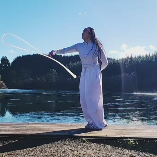 A girl skipping beside a lake in New Zealand 