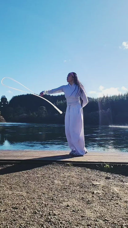 A girl skipping beside a lake in New Zealand 